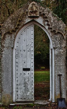 an old stone building with a large wooden door