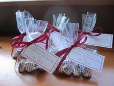 some cookies wrapped in plastic wrap and tied with red ribbon are sitting on a table