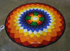 a multicolored round rug with scissors on the floor