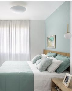 a bedroom with blue walls and white curtains