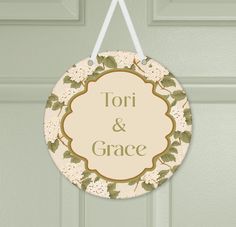 a sign hanging from the side of a door that says tori and grace on it