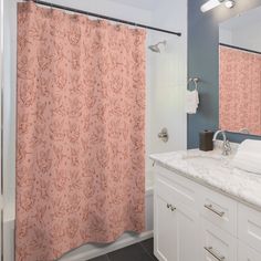 a bathroom with a sink, mirror and shower curtain in it's center area