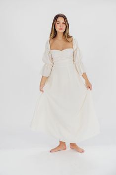 Feminine and sweetly elegant, the Corrine Maxi is guaranteed to sweep you off your feet! It features an incredible sweetheart neckline that can be worn on or off the shoulder, plus renaissance-style statement sleeves and a full, sweeping skirt. It's almost too easy to pair this dress with boots for an outdoor photo shoot, or with sleek pumps for a wedding or baby shower! The Corrine dress is already a Worth Co. fan favorite, so don't wait too long to snag yours! Available in multiple colorways. Feminine Lined Midi Dress With Sweetheart Neckline, Feminine White Midi Dress With Lined Bodice, White Feminine Empire Waist Midi Dress, Feminine Cream Midi Dress For Brunch, Cream Dress With Smocked Bodice For Wedding, Elegant White Midi Dress With Smocked Bodice, Cream Wedding Dress With Smocked Bodice, White Midi Dress With Smocked Bodice And Sweetheart Neckline, Cream Feminine Dress With Smocked Bodice