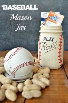 a mason jar filled with peanuts next to a baseball