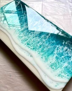 a blue and white glass plate sitting on top of a sheet of plastic covering the table