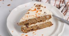 a piece of carrot cake on a plate with a fork