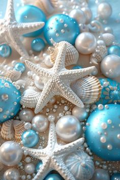 starfish, pearls and other sea shells are arranged on a blue background with white ornaments