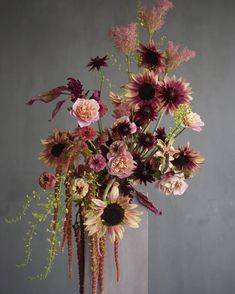 a vase filled with lots of different types of flowers