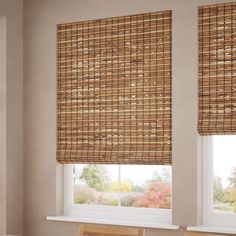 two windows with bamboo blinds in a dining room, one is closed and the other is closed