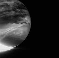 an image of the moon taken from space in black and white, with some clouds