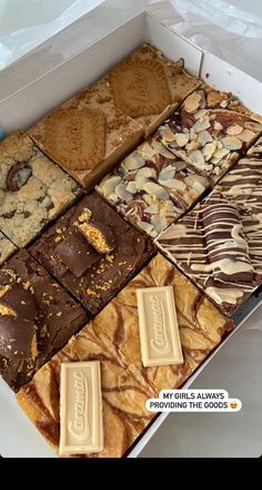 a box filled with lots of different types of cookies and desserts on top of each other