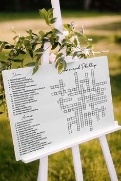 a crossword sign with greenery on it