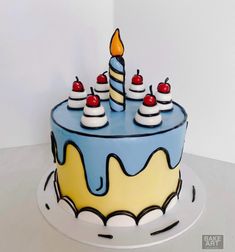 a birthday cake decorated with candles and cherries