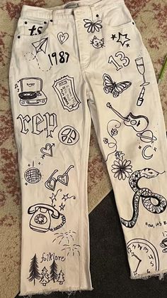 a pair of white jeans with drawings on them