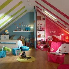 a bedroom with pink, green and blue decor on the walls is pictured in this image