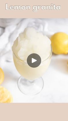 lemon granita in a glass with ice cream and sliced lemons around the rim