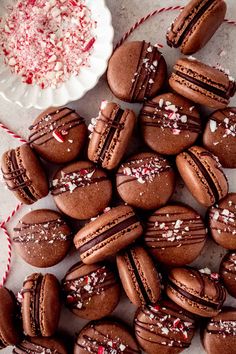 chocolate macaroons with sprinkles and peppermint on a plate