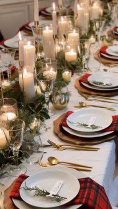 the table is set with place settings and candles for christmas dinner guests to sit at