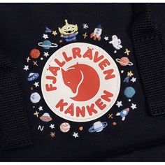 an embroidered patch on the back of a black backpack with space and stars around it