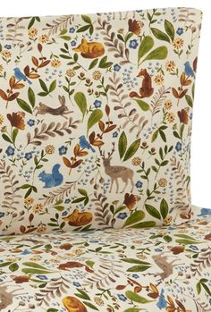 an upholstered chair with floral print on the seat and back cover, in front of a white background