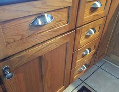 a close up of a wooden cabinet with metal knobs