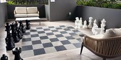 a living room filled with furniture and chess pieces