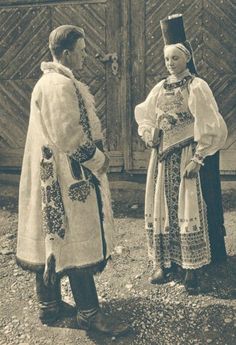 an old black and white photo of two women in traditional russian garb talking to each other