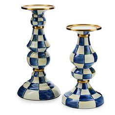 two blue and white checkered candlesticks with gold rimmed holders on each side