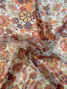 This multicolor floral harvest printed crinkled silk chiffon designer fashion fabric in orange and red features a cushion of color in festive seasonal shades. SKU: 8675 Content: 100% Silk Color: Orange / Red / Multicolor Width: 54 inches This fabric is a last cut and no longer in production. Once sold out, we are unable to get more. Luxury Multicolor Fabric For Festive Season, Luxury Multicolor Festive Fabric, Fall Florals Fabric, Luxury Orange Floral Print Sets, Orange Chiffon, Novelty Fabric, Brocade Fabric, Silk Organza, Silk Twill