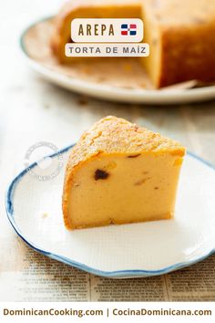 a piece of cake sitting on top of a blue and white plate next to a newspaper