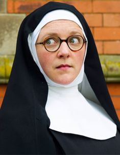 a woman wearing glasses and a nun outfit