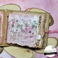 a handmade greeting card with flowers and words on the front, sitting on top of a piece of wood