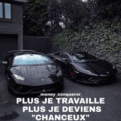 two black sports cars parked next to each other in front of a brick building with the words money conquerer plus je travaille plus je devens changeux