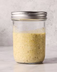 a glass jar filled with food sitting on top of a counter