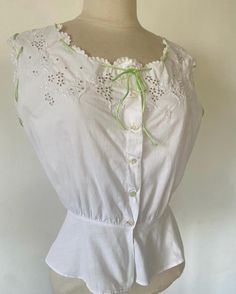 This is a genuine Edwardian camisole dating from the 1920s. It has a monogram that can be read as EF / CF / EP / CF.  It features ribbons around the collar but also circling both shoulders. At the front of the piece, butterflies flying around flowers are depicted through embroideries and eyelets.  The collar and shoulders ends in scalloped arches. It is in excellent condition without flaws to note  It will fit a size small.  Please message me if you would like additional information ! Edwardian Camisole, Camisole Pattern, Butterflies Vintage, Corset Cover, Edwardian Corsets, Butterflies Flying, Silk Camisole, Fashion Inspiration, Vintage Art