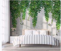 a bed sitting under a green plant covered wall