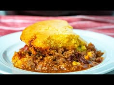 a close up of a plate of food with meat and cornbreads on it