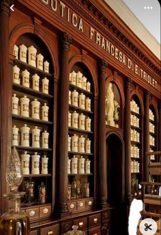 an old fashioned pharmacy cabinet with many jars on it