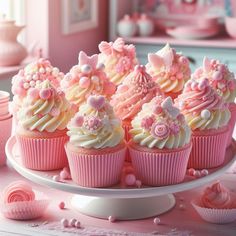 there are many cupcakes on the plate with pink frosting and decorations around them