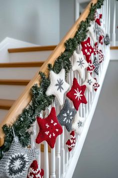 christmas decorations hanging on the banisters and handrail in a home decorated with red, white and green knitted ornaments