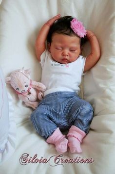 a baby is sleeping with her stuffed animal