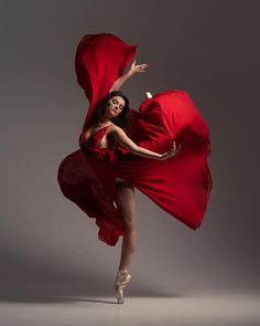 a woman in a red dress is dancing