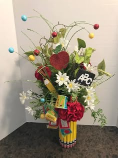 a vase filled with lots of flowers and candy