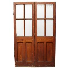 an old wooden double door with glass panels