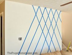 a living room with blue lines painted on the wall