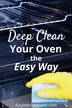 a hand with a sponge on top of an oven and the words deep clean your oven the easy way