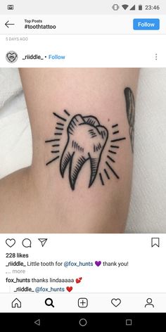 a tooth tattoo on the side of a woman's arm