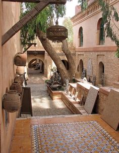 an outdoor courtyard with benches and potted plants