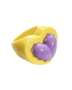 a yellow and purple ring with an elephant on it's side, sitting in front of a white background