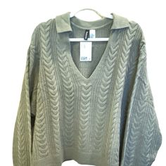 Nwt. Adorable V-Neck Cable Knit Sweater With Collar. Solid Color In Khaki Green. Ribbed Sleeves And Hem. Dropped Shoulders. Regular Length. Fit: Relaxed Fit Content: 100% Acrylic This Sweater Was Only On A Hanger For Photo Purposes Only. This Item Comes From A Smoke Free Home Same Or Next Day Shipping Except On Sundays And Holidays Thank You For Looking!!! H&m Knit Tops For Fall, Oversized H&m Winter Tops, Fall Knit Tops By H&m, Green Soft Knit V-neck Top, Green V-neck Soft Knit Top, H&m Knit V-neck Top, Fall Knitted Tops From H&m, H&m V-neck Sweater For Spring, Cozy Cable Knit V-neck Top